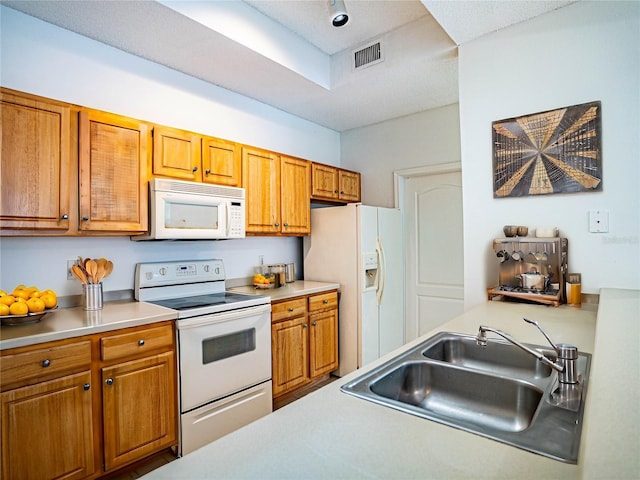 kitchen with sink and white appliances