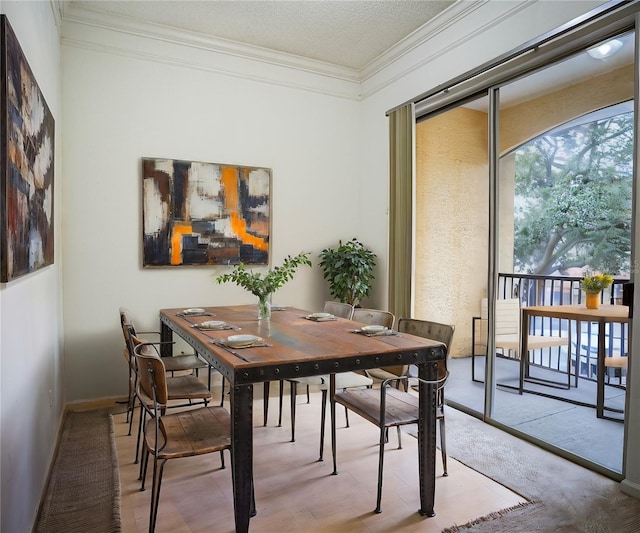 dining room featuring a textured ceiling and crown molding