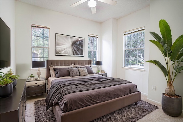 bedroom with ceiling fan and light colored carpet