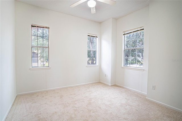 empty room with ceiling fan and light colored carpet