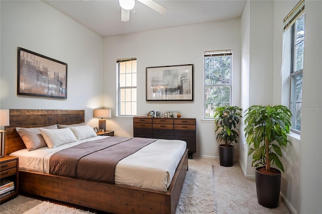 bedroom with ceiling fan and light colored carpet