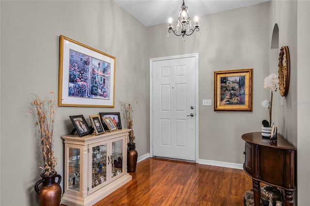 entrance foyer featuring a notable chandelier and dark hardwood / wood-style floors