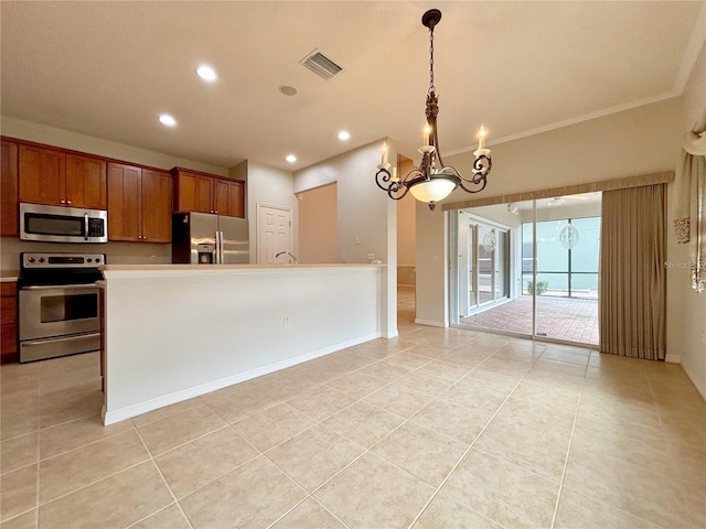 kitchen with light tile patterned floors, appliances with stainless steel finishes, decorative light fixtures, a chandelier, and a center island