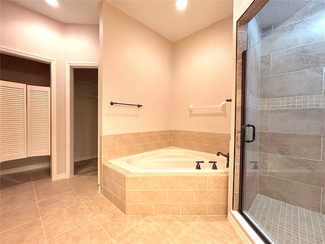 bathroom with independent shower and bath and tile patterned flooring