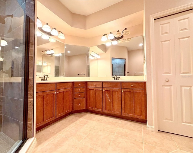 bathroom with vanity, tile patterned flooring, and a shower with door