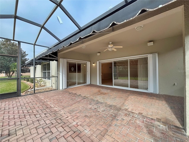 unfurnished sunroom featuring ceiling fan