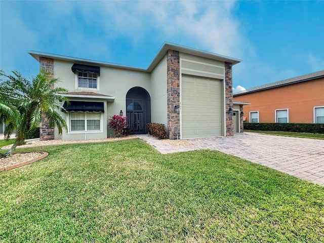 view of front of home with a front yard and a garage