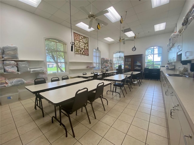 dining area with ceiling fan, sink, and light tile patterned floors