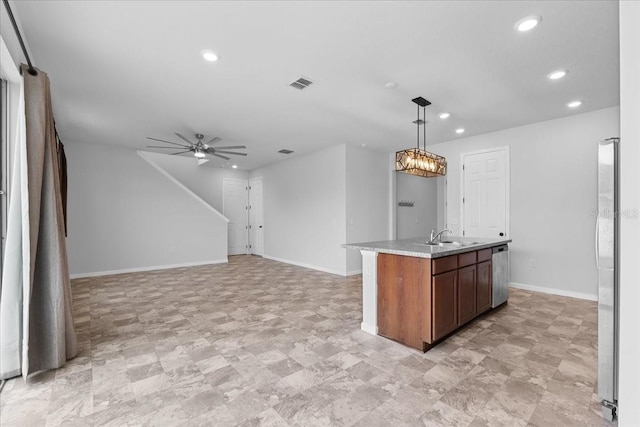 kitchen featuring stainless steel appliances, ceiling fan, sink, a center island with sink, and hanging light fixtures