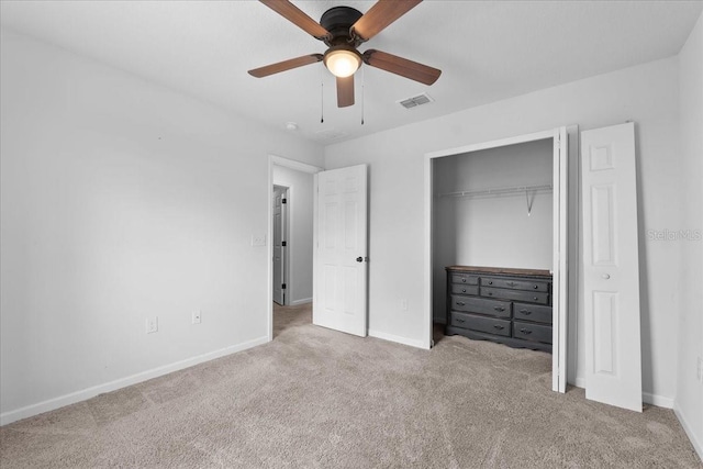 unfurnished bedroom with ceiling fan, light carpet, and a closet