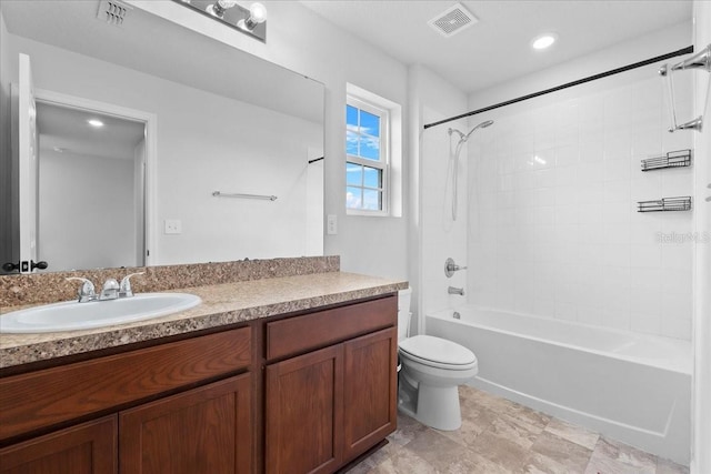 full bathroom featuring washtub / shower combination, vanity, and toilet