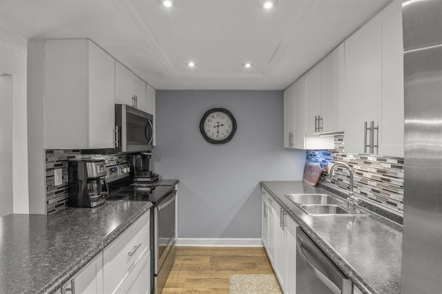 kitchen featuring white cabinets, sink, and stainless steel appliances