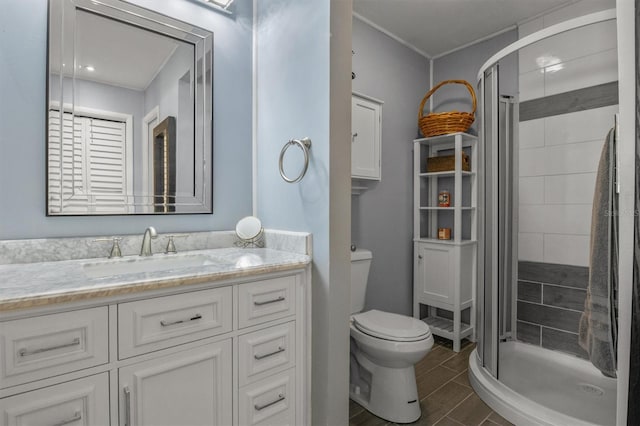 bathroom with toilet, walk in shower, and vanity