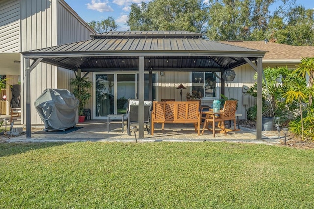 rear view of property featuring a gazebo, a yard, and a patio