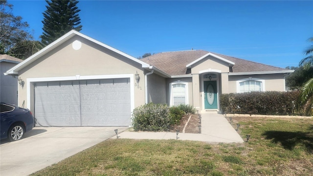 single story home with a garage and a front lawn