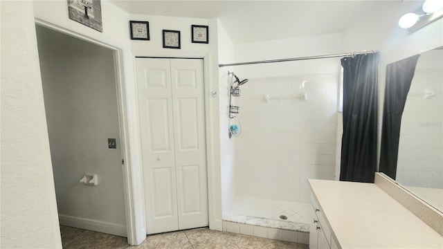 bathroom featuring vanity, curtained shower, and tile patterned floors