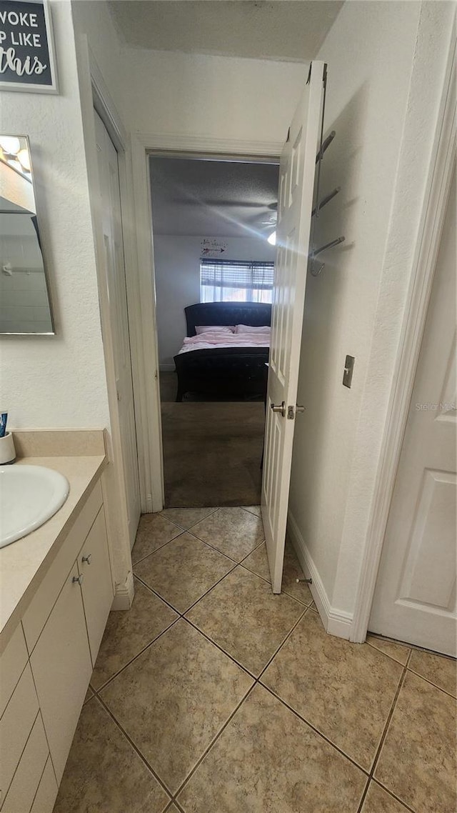 bathroom featuring tile patterned flooring and vanity