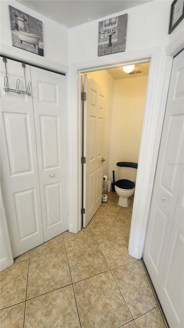 bathroom with tile patterned floors and toilet