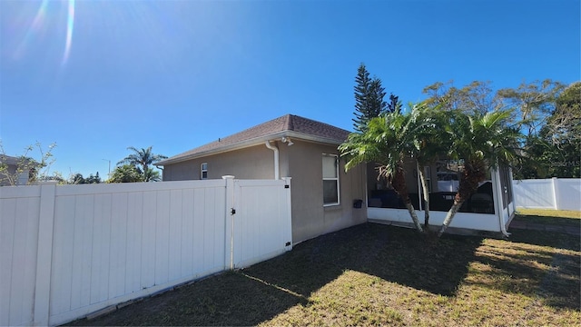 view of side of home featuring a lawn