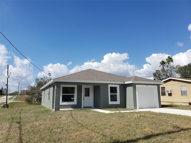 view of front facade with a garage and a front lawn