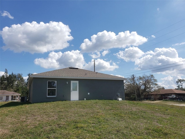 back of property featuring a yard