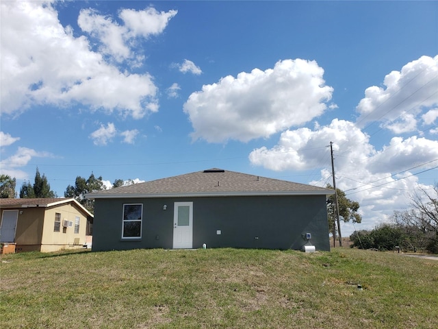 back of house featuring a yard