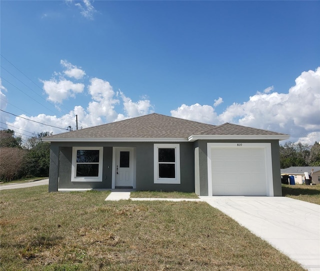 ranch-style house with a garage and a front lawn