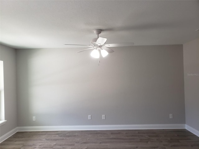 unfurnished room with ceiling fan and dark hardwood / wood-style flooring