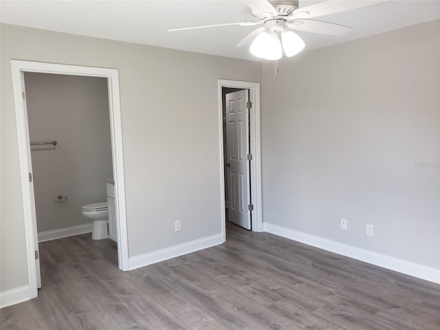 unfurnished bedroom featuring hardwood / wood-style flooring, ensuite bath, and ceiling fan