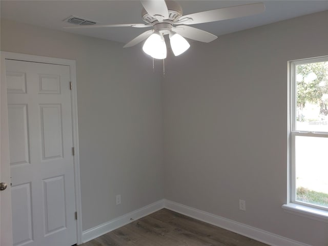 spare room featuring dark hardwood / wood-style floors and ceiling fan