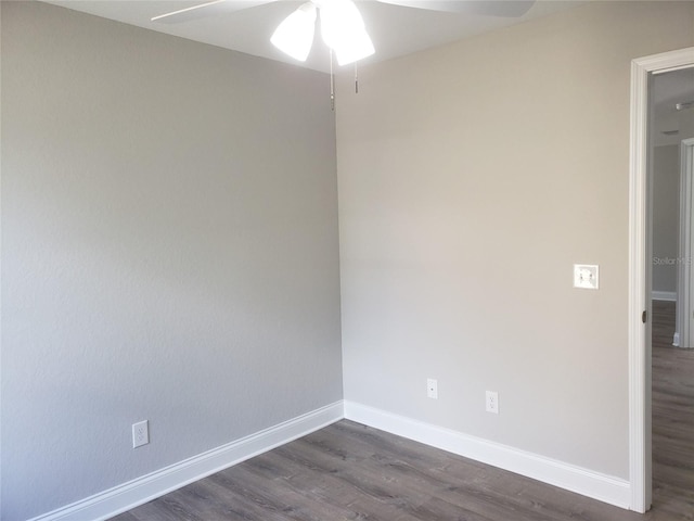 empty room featuring ceiling fan and dark hardwood / wood-style flooring