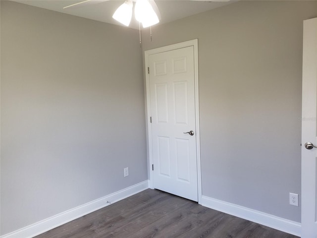 spare room featuring ceiling fan and dark hardwood / wood-style flooring