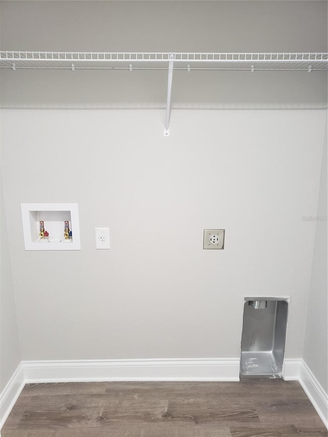 clothes washing area with dark wood-type flooring, hookup for an electric dryer, and hookup for a washing machine