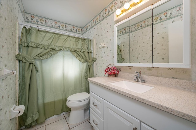 bathroom with toilet, vanity, and tile patterned floors