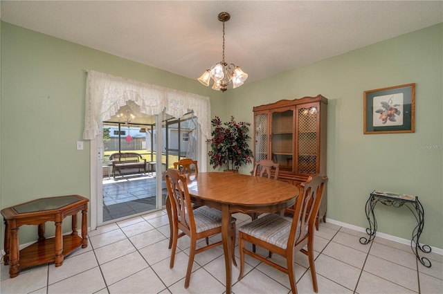 tiled dining room featuring a notable chandelier