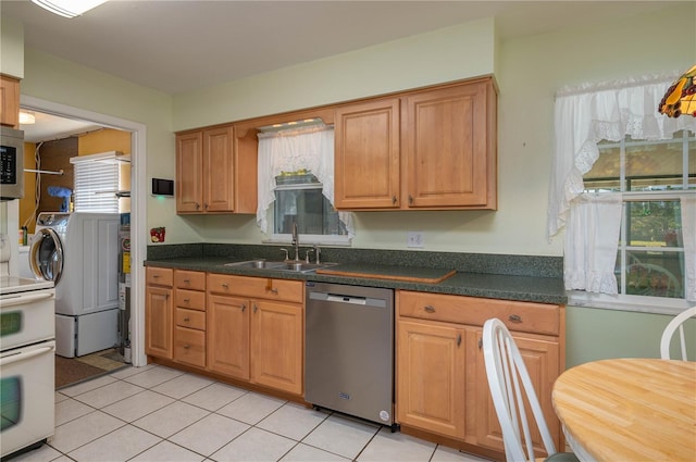 kitchen featuring sink, stainless steel appliances, and light tile patterned floors