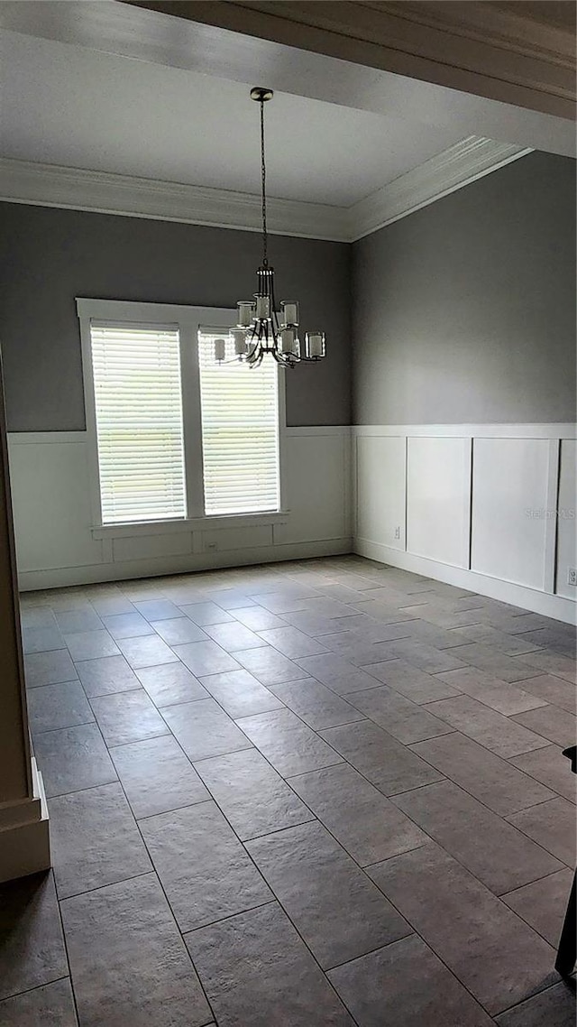 unfurnished dining area featuring light tile patterned flooring, crown molding, and a notable chandelier