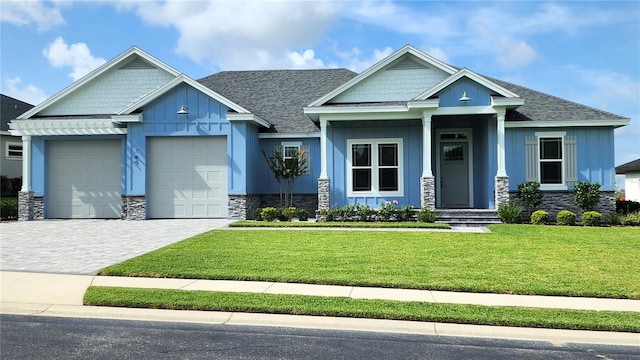 craftsman inspired home with a front yard and a garage