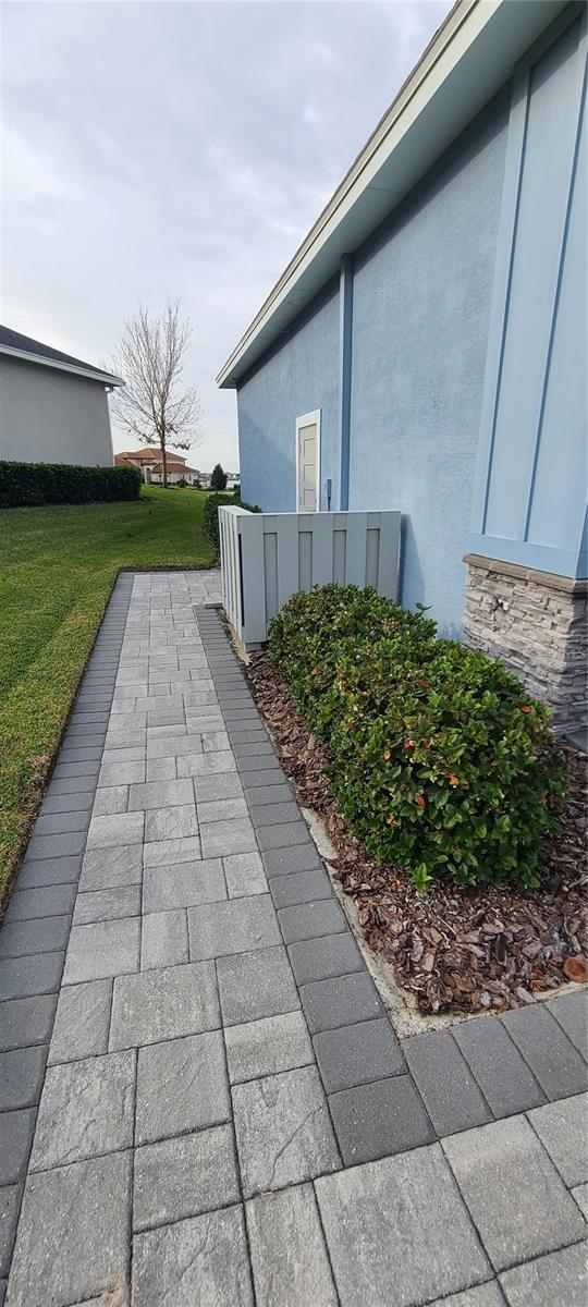 view of side of home with a lawn