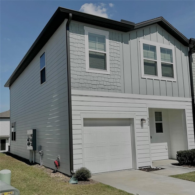 view of side of home featuring a lawn and a garage