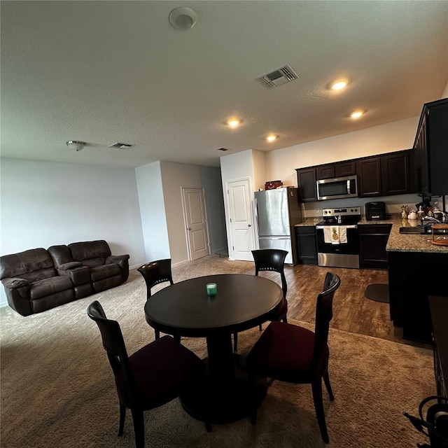 carpeted dining room featuring sink