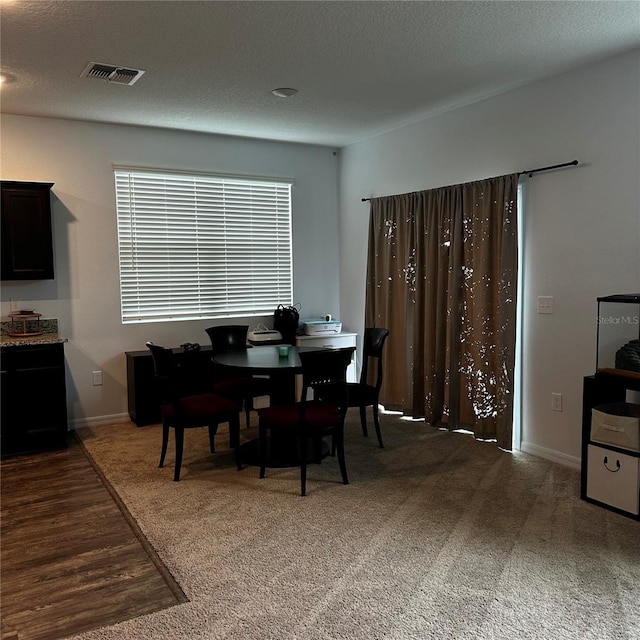 dining area with dark carpet