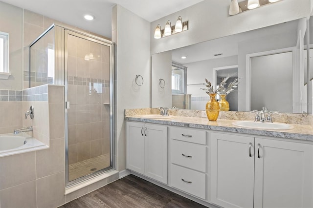 bathroom featuring vanity, independent shower and bath, and hardwood / wood-style flooring