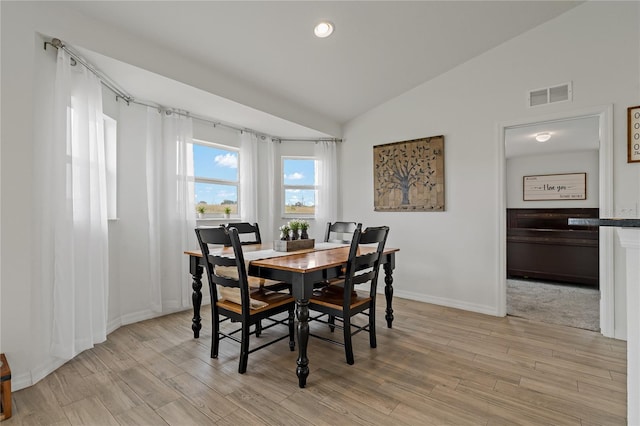 dining space with vaulted ceiling