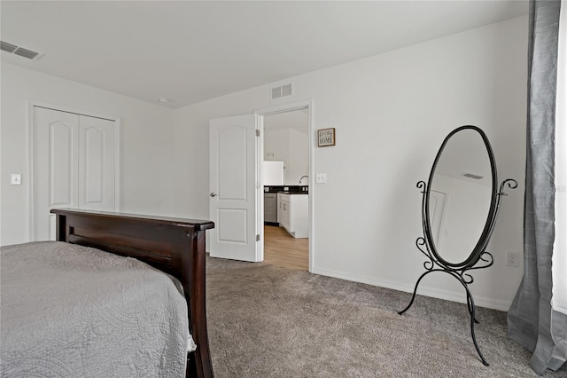 bedroom with a closet and light colored carpet