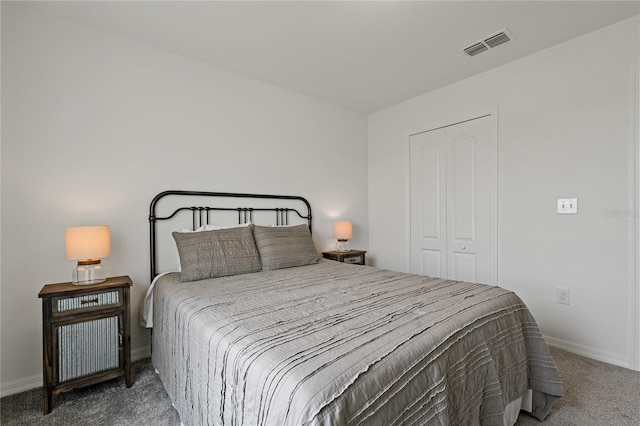 bedroom featuring dark colored carpet and a closet