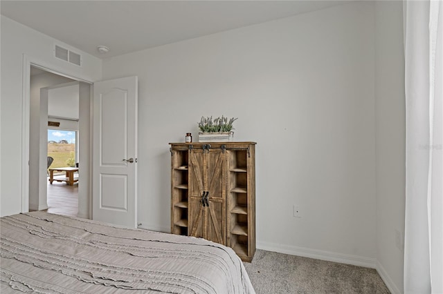 bedroom with light colored carpet