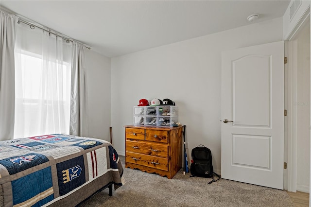 bedroom with light colored carpet