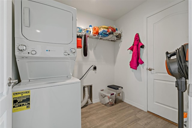 laundry room with stacked washer / dryer