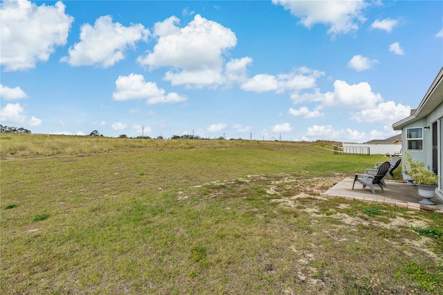 view of yard featuring a patio and a rural view